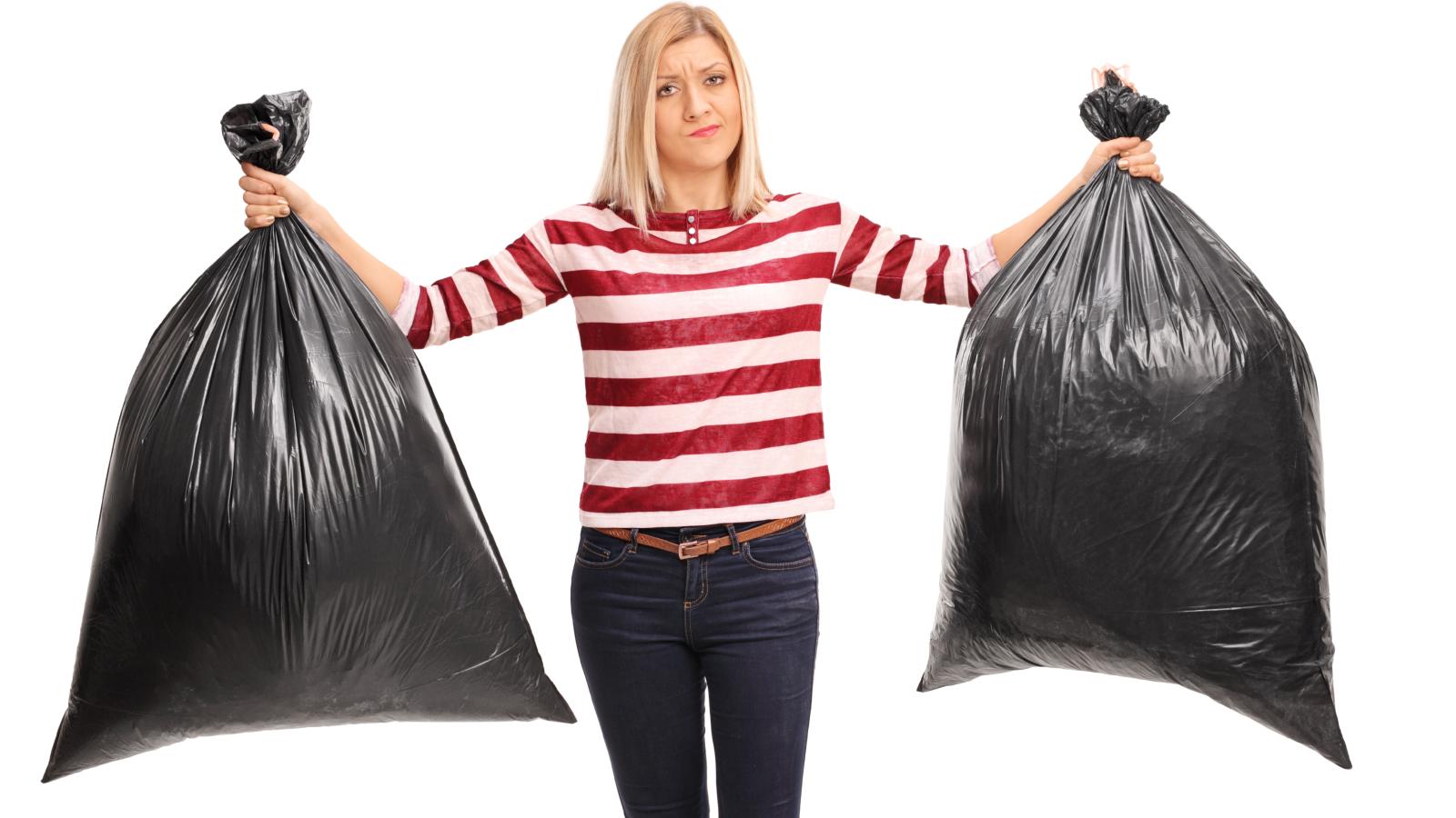 woman holding trash bags