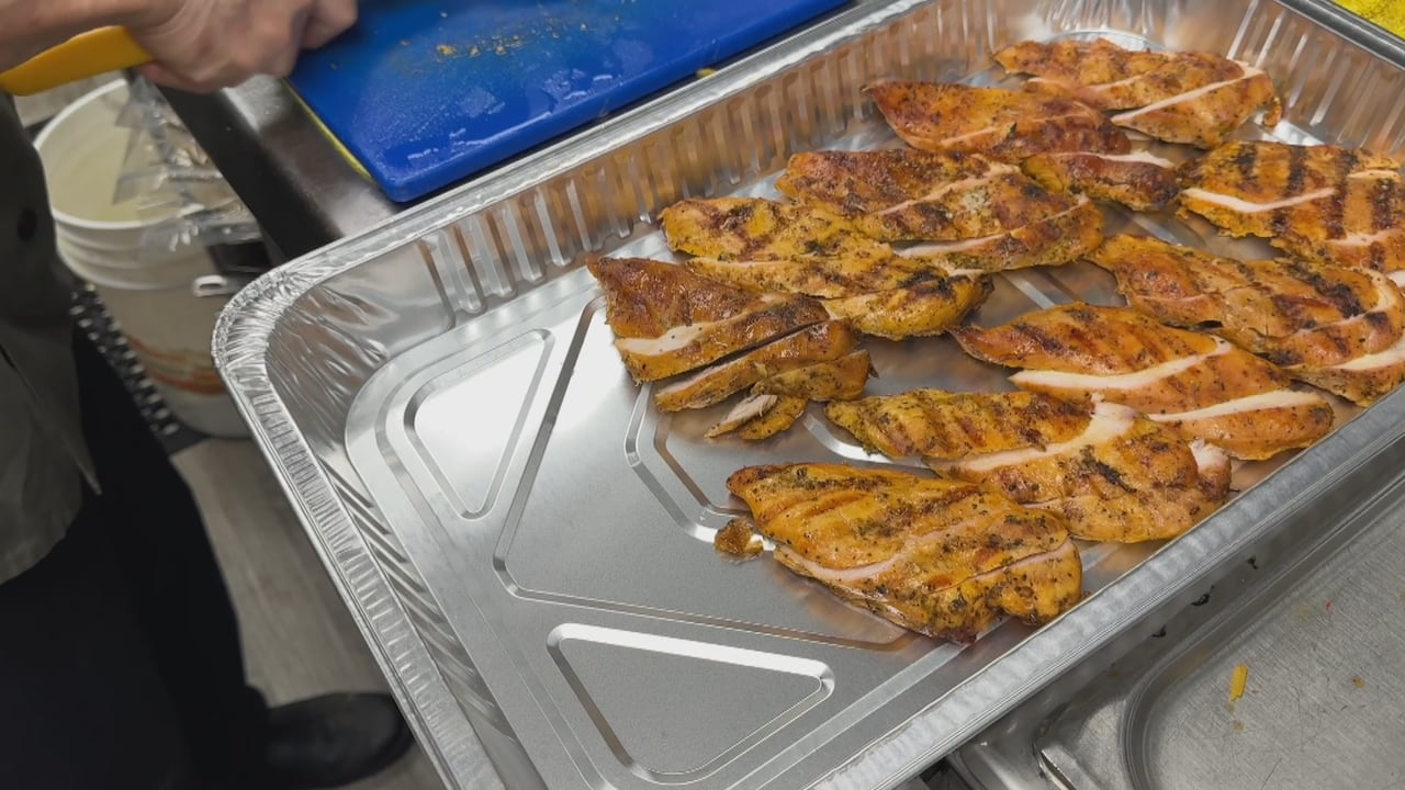 A tinfoil tray full of sliced halal chicken