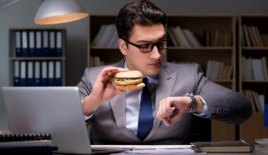 Businessman late at night eating a burger