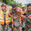 In this photo provided by the Nepal Army, soldiers rescue a worker alive from a tunnel during an ongoing operation at the Trishuli-3A hydropower project in Nepal's Rasuwa district, Friday.