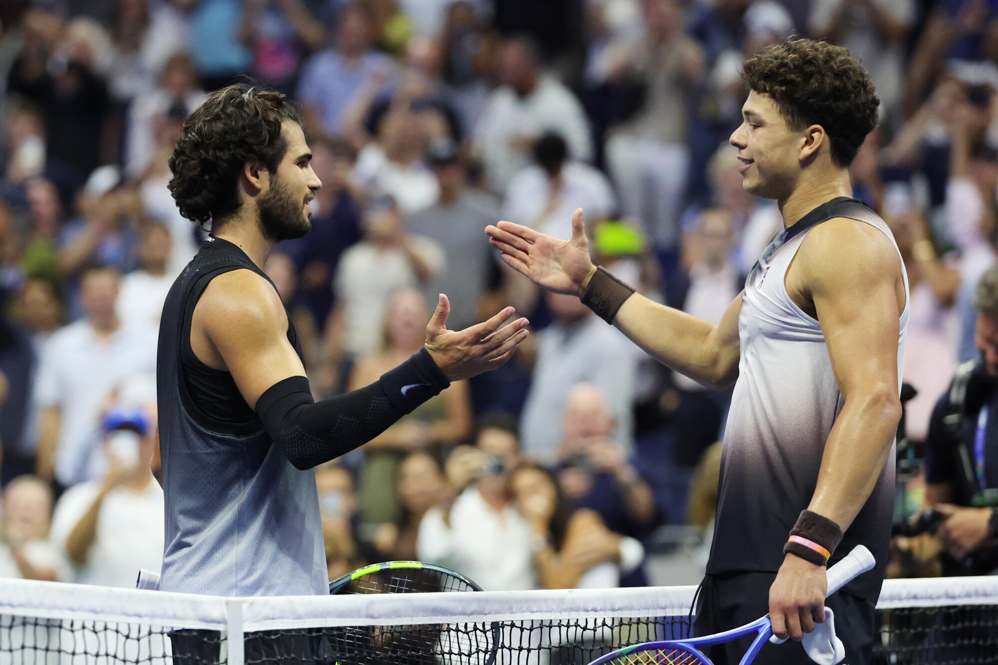 Ben Shelton is congratulated by Carlos Alcaraz after winning their U.S. Open quarterfinal match after 3 a.m. EDT.