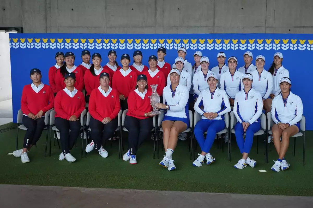 United States team, left ,and Europe team right pose for the media during a photocell for the Solheim Cup at the Bernardus Golf course in Vught, Netherlands, Tuesday, Sept. 8, 2026. (AP Photo/Alastair Grant)