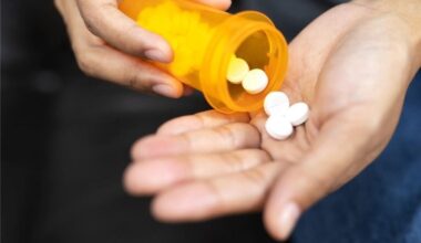 Man Pouring Drugs into Hand Medicine Aspirin