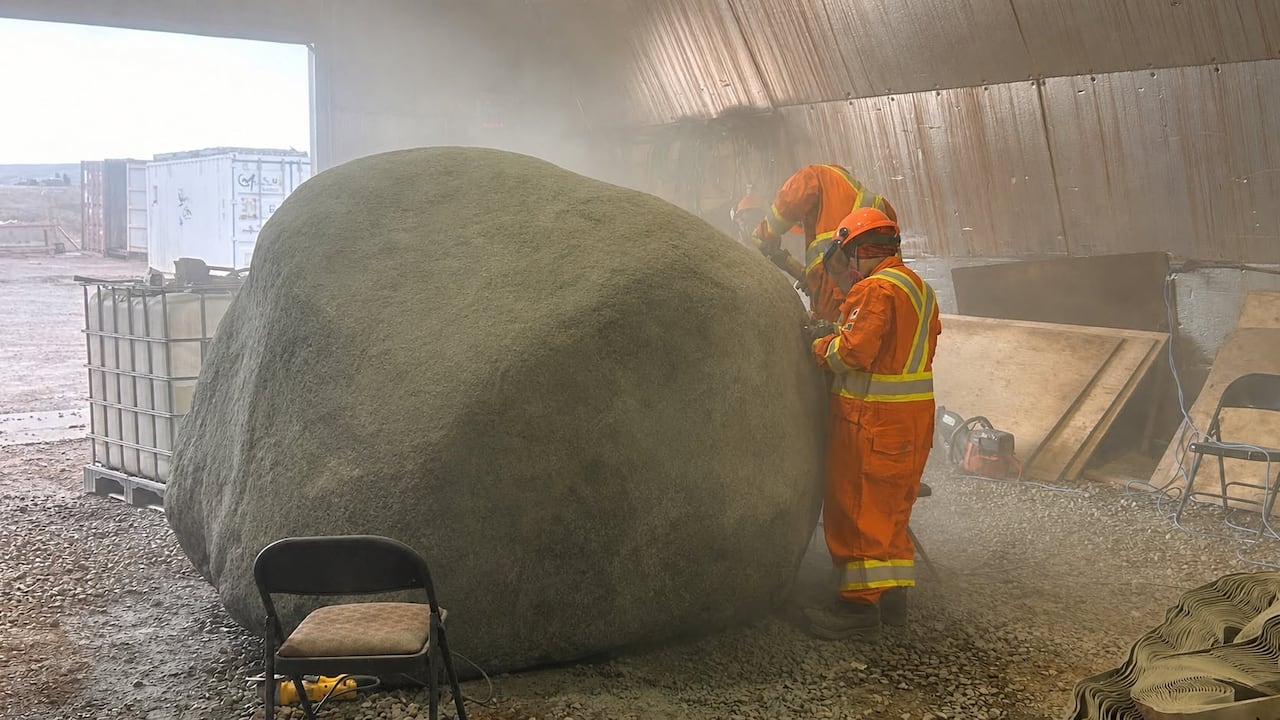 People carve rock.