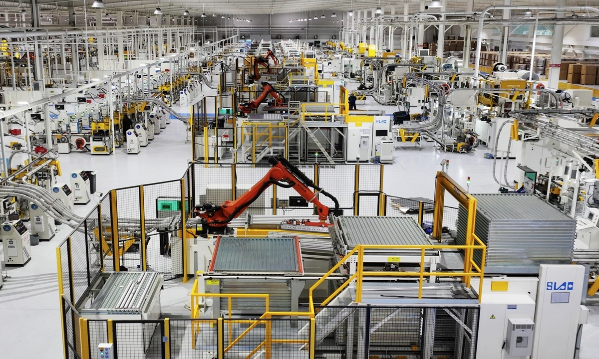 Industrial robots are operating on an intelligent production line in a smart manufacturing enterprise in Yangzhou, East China
