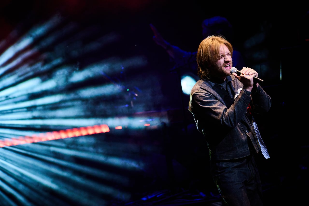 A man sings on stage