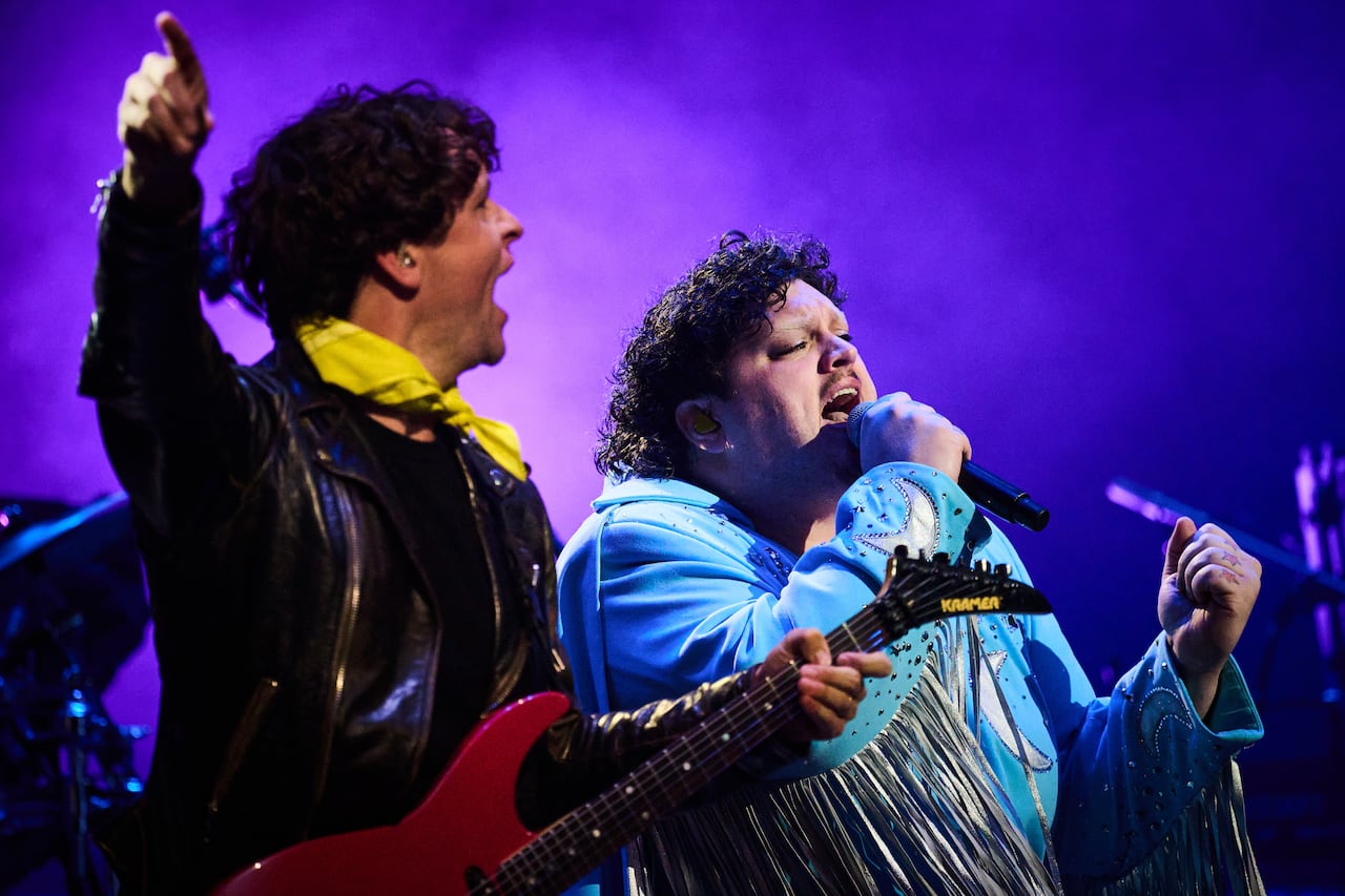 Two musicians perform on stage