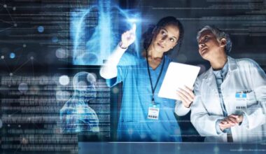 Medical workers examine an x-ray or scan in a hospital laboratory.