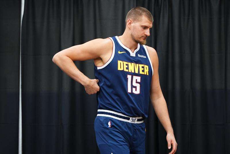 Denver Nuggets center Nikola Jokić enters a news conference during the NBA basketball team's media day Monday, Sept. 28, 2026, in Denver. (AP Photo/David Zalubowski)