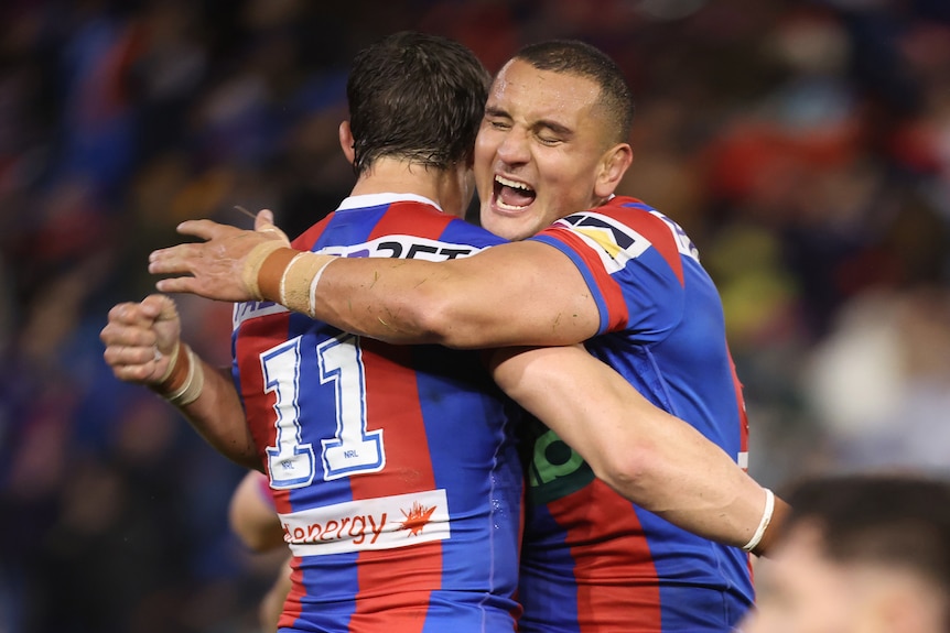 Mat Croker and another player celebrate after scoring a try in a rugby league match.