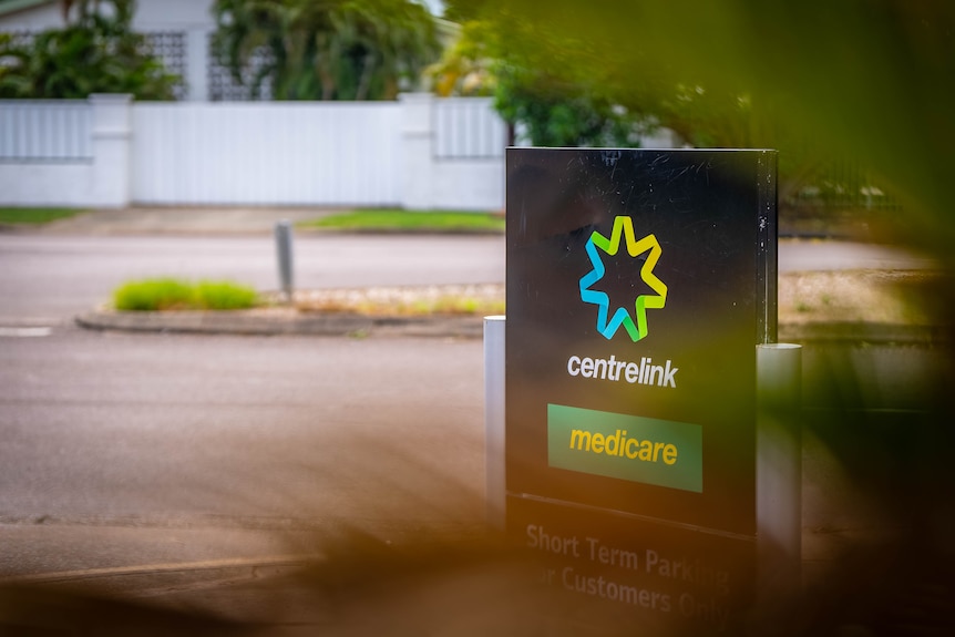 A ground-mounted sign for Centreiink and Medicare, in front of a carpark.