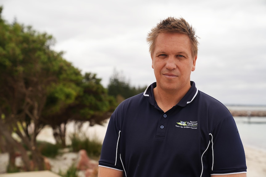 Middle aged man wearing a dark polo top