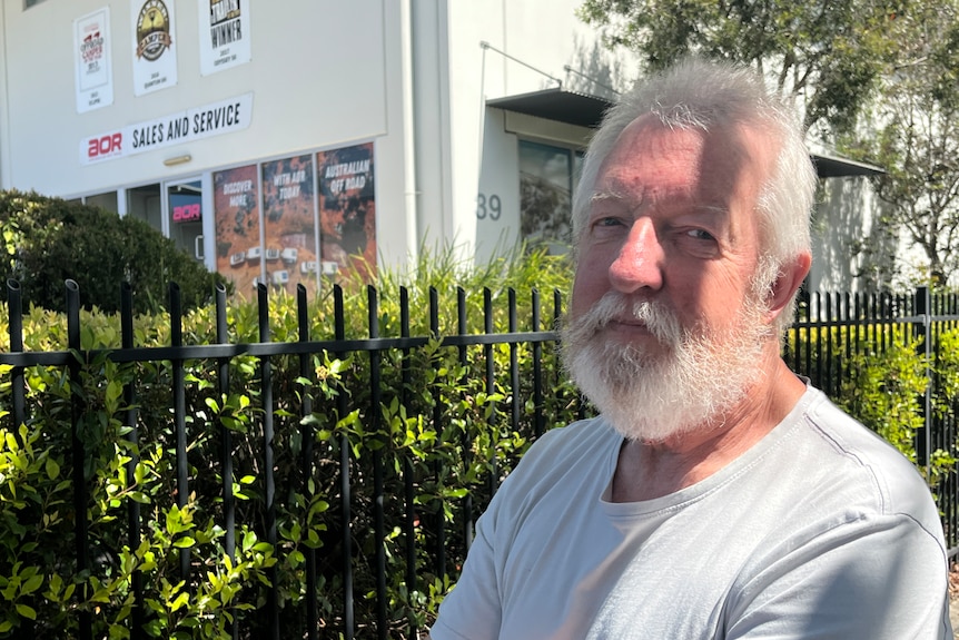 man in grey shirt looking at camera