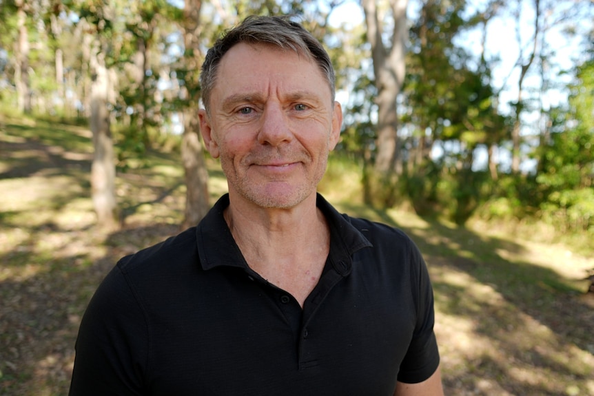Man half smiling looking in camera