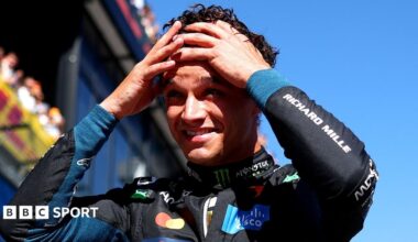 Lando Norris has both hands on his head and appears shocked after taking pole position for the Spanish Grand Prix