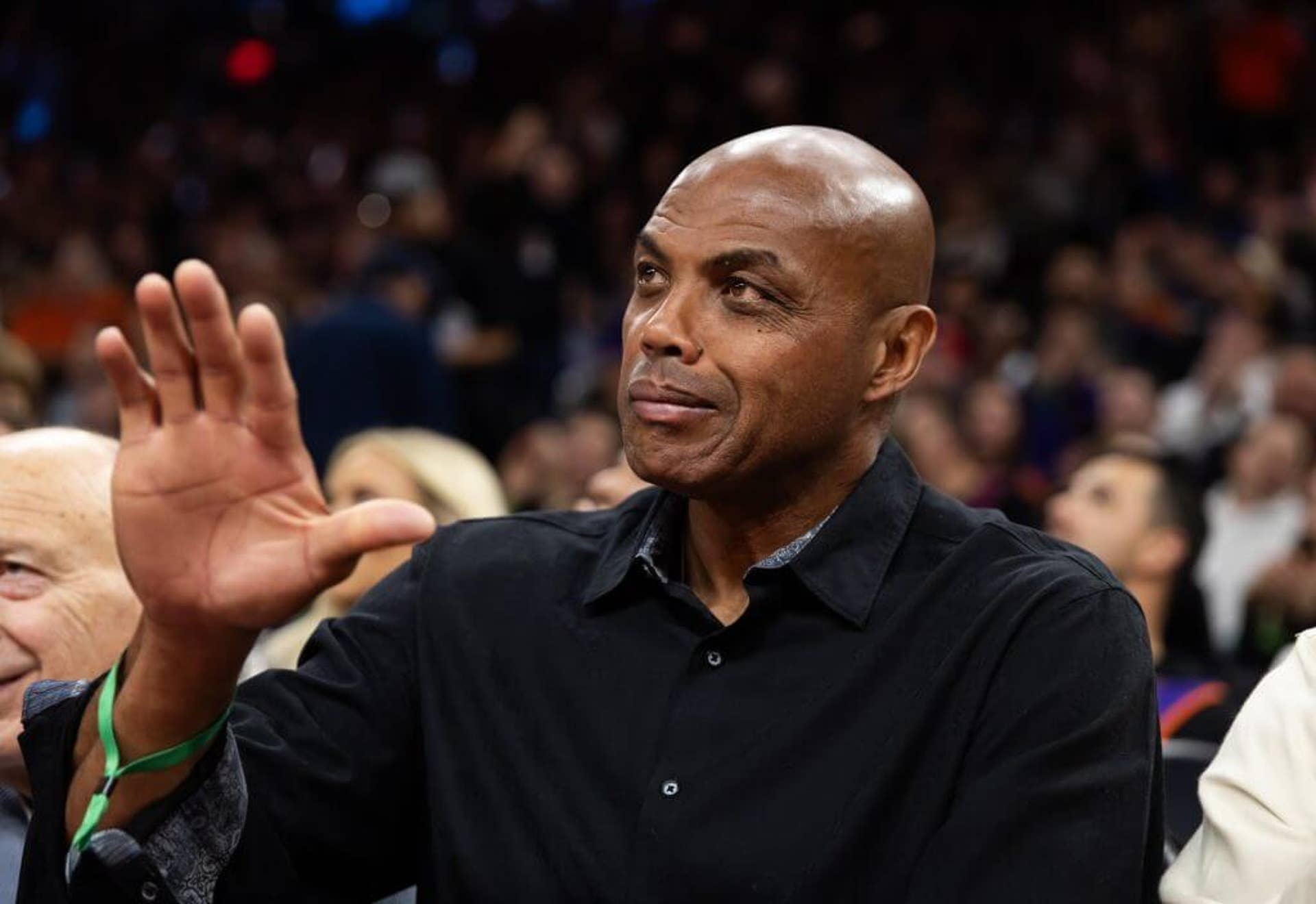 Charles Barkley sits courtside during a Phoenix Suns game against the Minnesota Timberwolves during the NBA Cup.