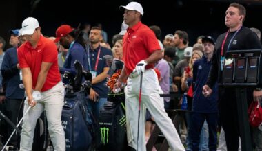 Tiger Woods of Jupiter Links GC stretches his left leg next to Tom Kim during warms up before match against the Los Angeles Golf Club who won the TGL finals at SoFi Center on March 24, 2026, in Palm Beach Gardens, Florida.