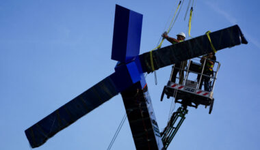 Crews work to remove the sculpture titled "Blue" by artist Joel Shapiro from the grounds of the Kennedy Center for the Per...
