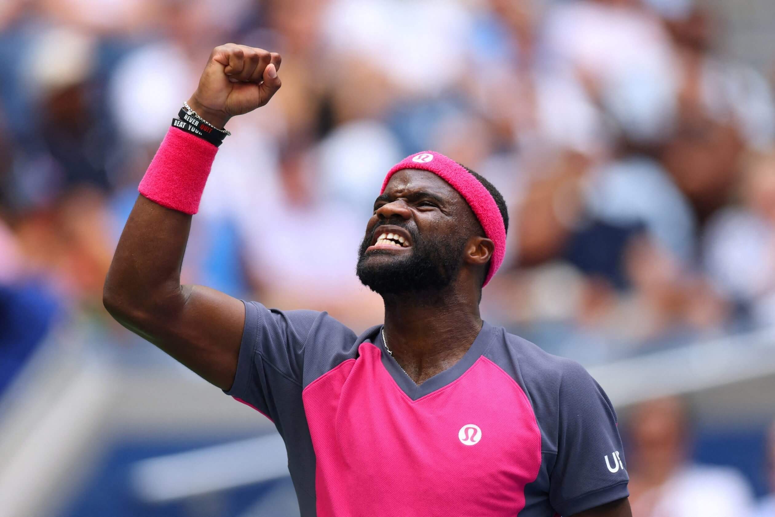 Frances Tiafoe raises his right arm and makes a grimacing expression in his quarterfinal at the 2026 U.S. Open.