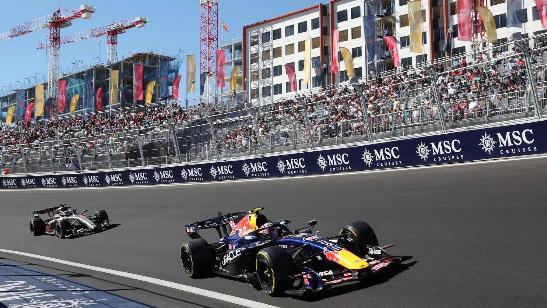 Liam Lawson (Red Bull-Ford) leads Nico Hulkenberg (Audi) on the Monumental corner during FP2 practice for the 2026 Spanish Grand Prix