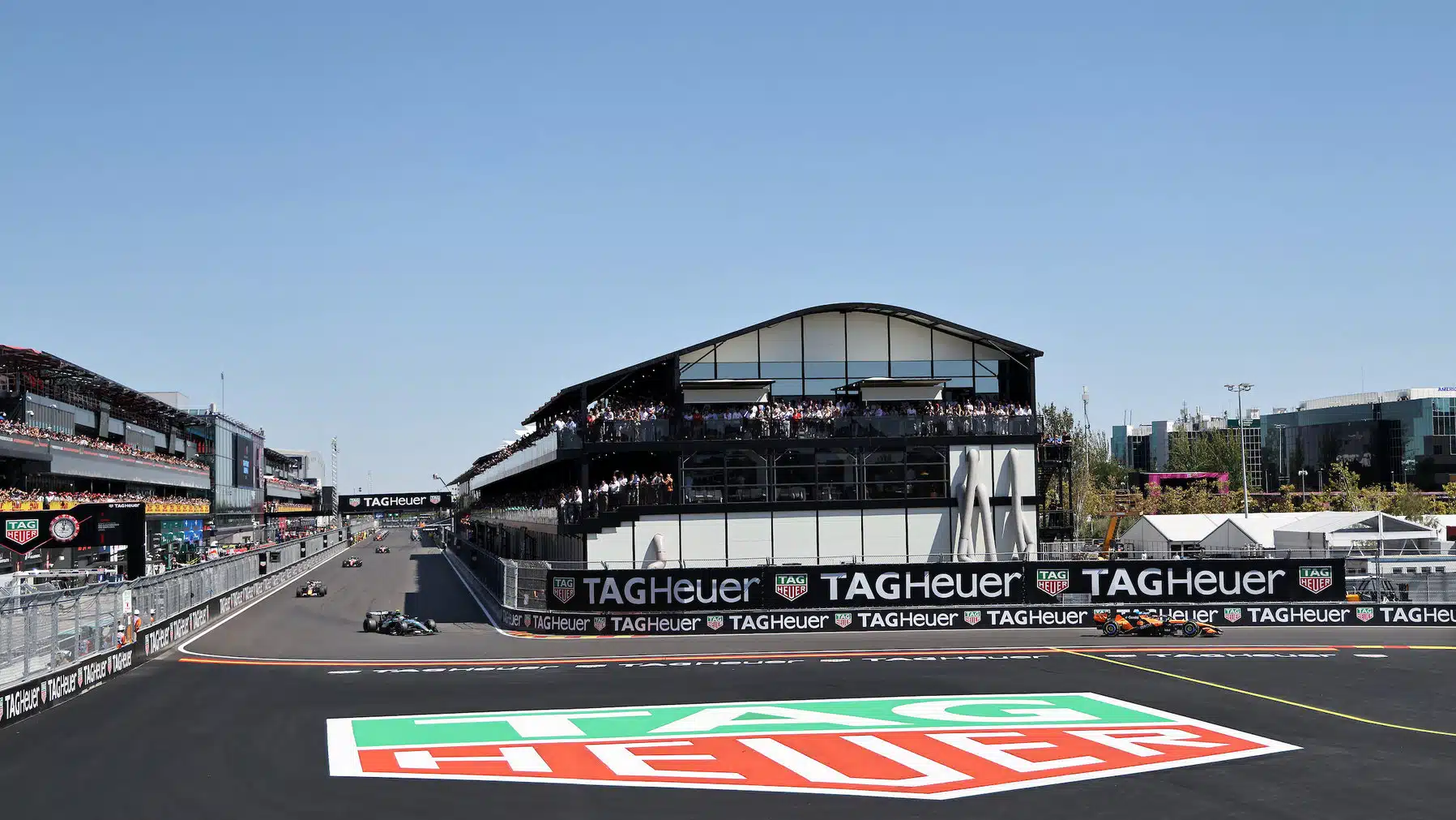 Lando Norris (McLaren-Mercedes) leads Kmi Antonelli (Mercedes) and the rest of the field on the warm-up / parade lap before the 2026 Spanish Grand Prix