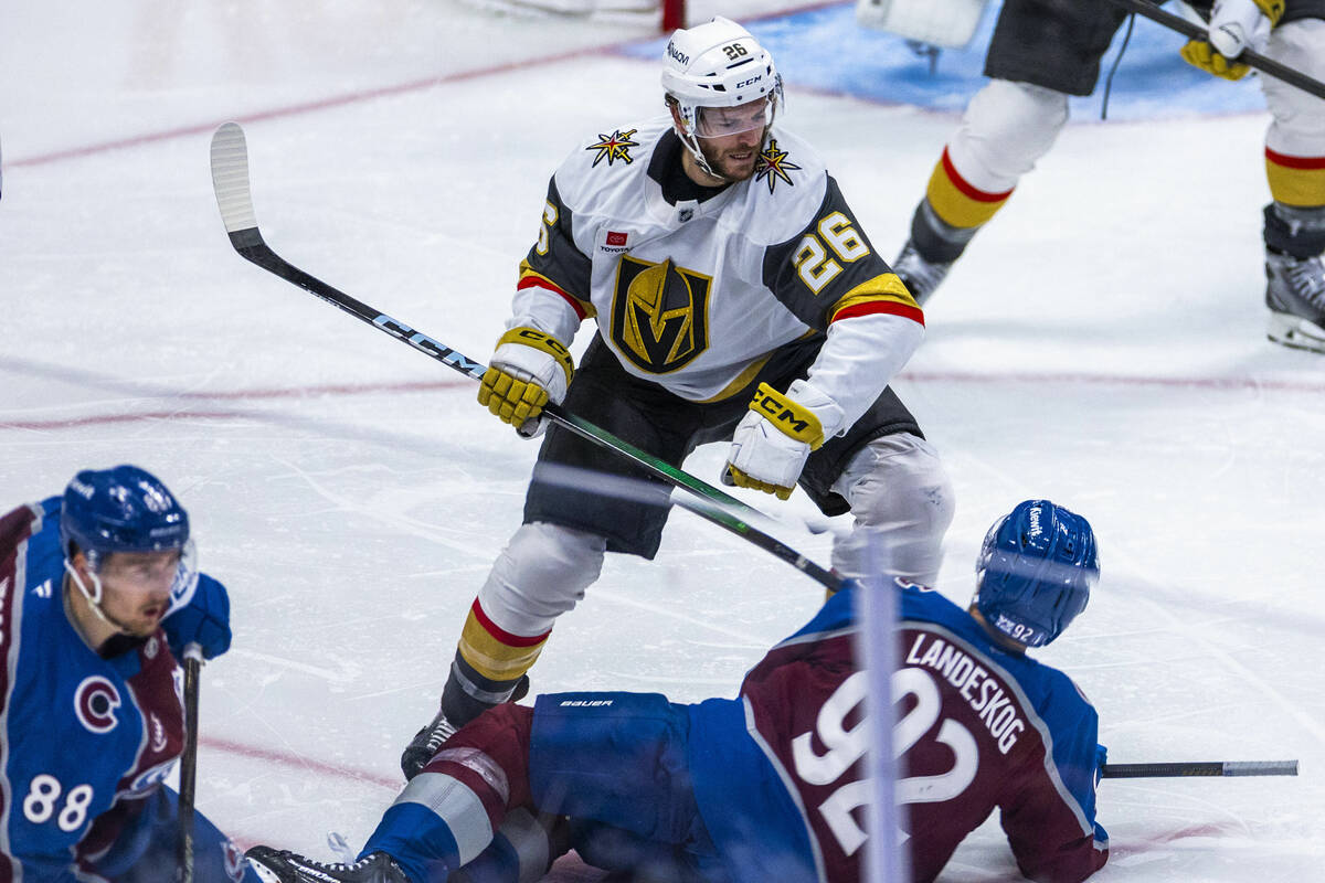Golden Knights center Nic Dowd (26) looks to Colorado Avalanche left wing Gabriel Landeskog (92 ...
