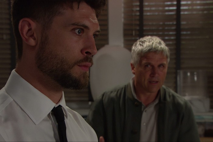 22_09_emm_joe_caleb_02 Caleb stares towards Joe in a scene from Emmerdale