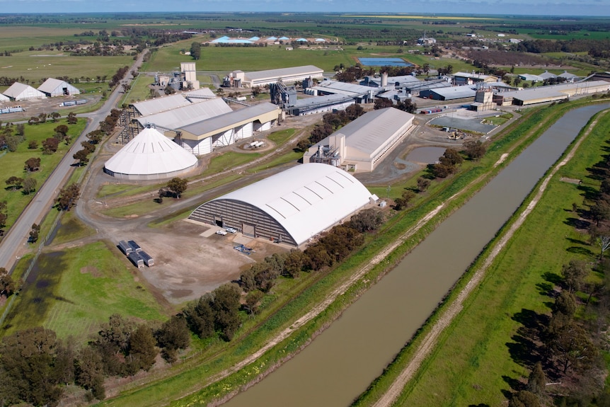 An aerial view of the Deniliquin rice mill showing industrial buildings and storage sheds.