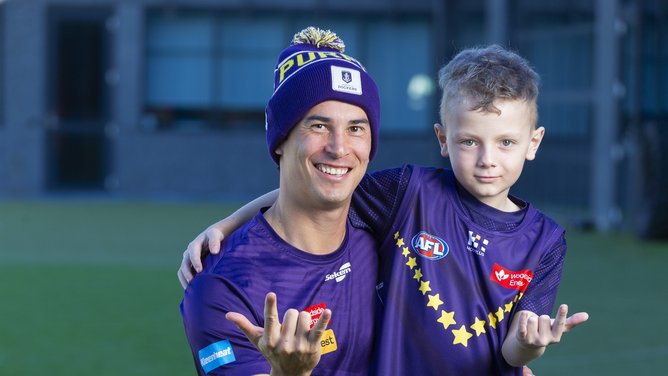 Bailey Banfield and Starlight kid Nicholas at the Dockers’ grounds in Cockburn in Perth.