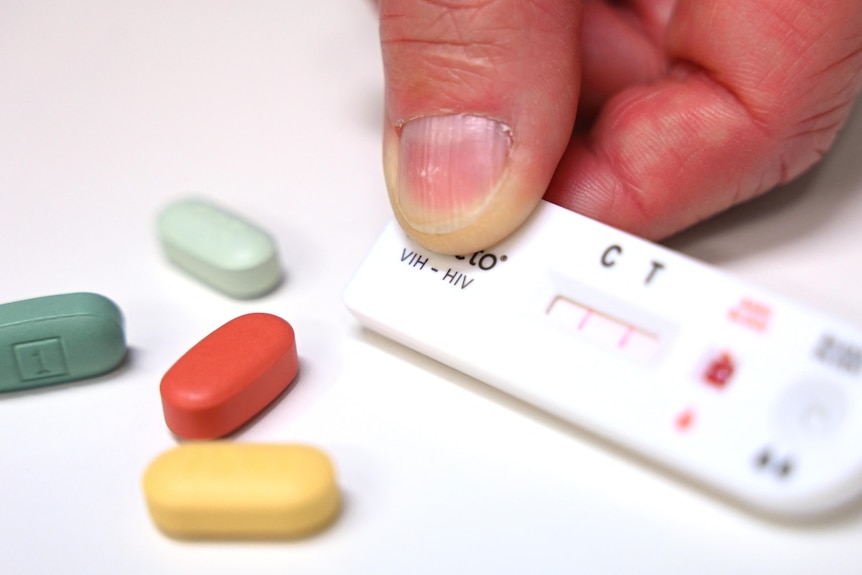 A testing cartridge for HIV and some pills.
