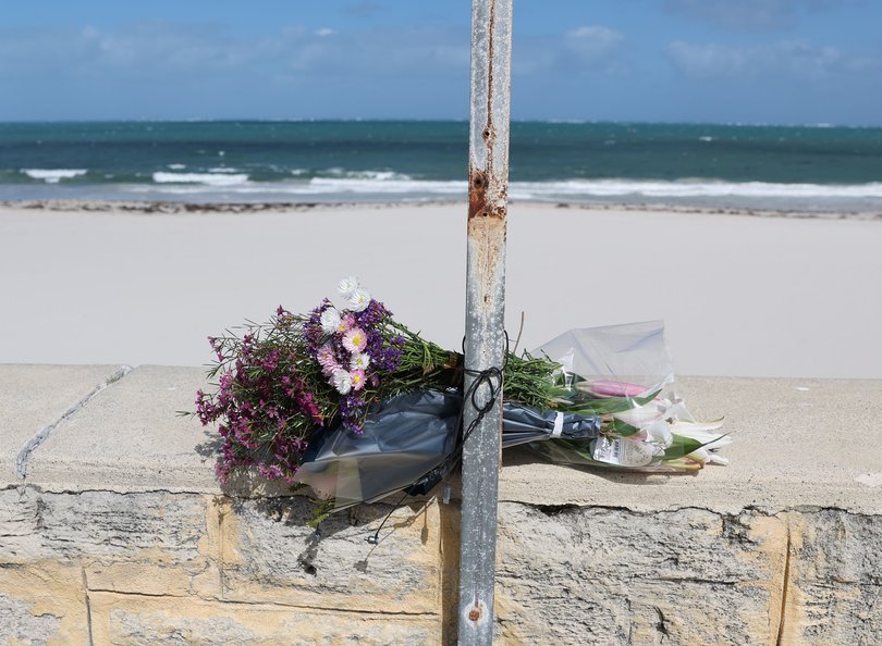 Flowers laid in tribute at Sorento Beach.