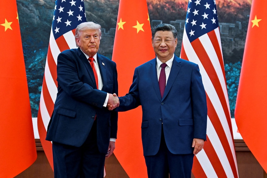 Two men shake hands. 