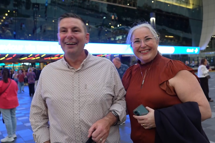 Jason and Kate stand together, smiling.
