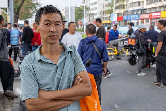Yang Zaiqiang, 43, a migrant worker from central China’s Hubei Province, waits in Majuqiao to be hired as a day labourer.