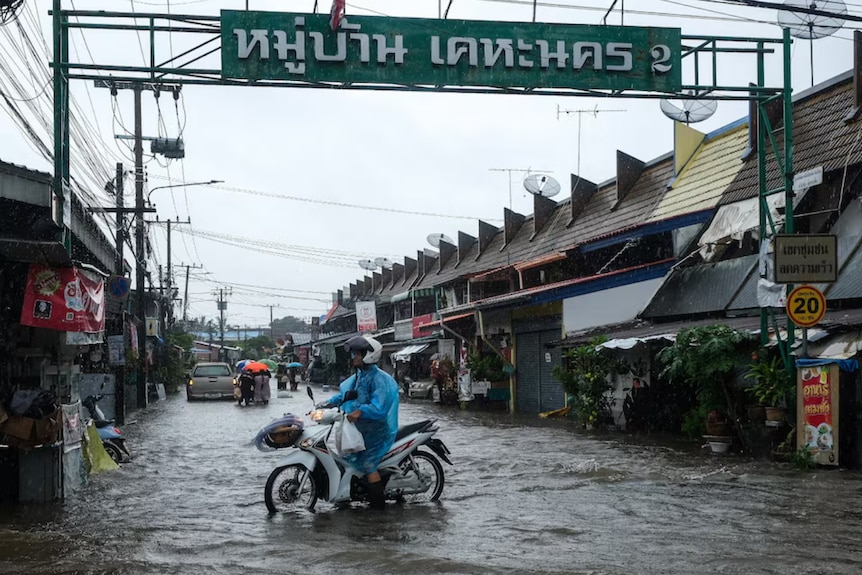 A motorbike rider in floodwaters.