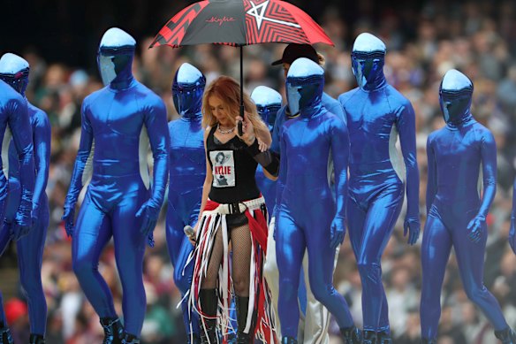 Kylie flanked by her Daft Punk-style dancers.
