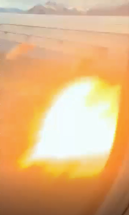 Flames spurt out of the engine of Sydney-bound Qantas flight QF122 shortly after take off from Queenstown