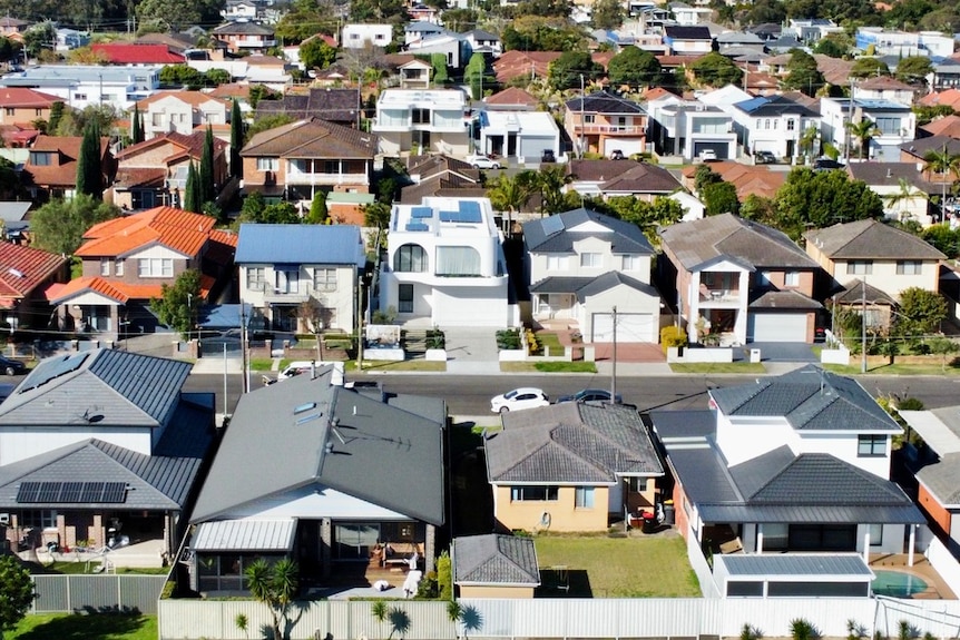 Large houses in a suburb, as seen from above on a sunny day.