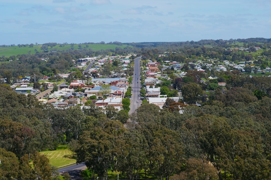 a town nestled in green rolling hills