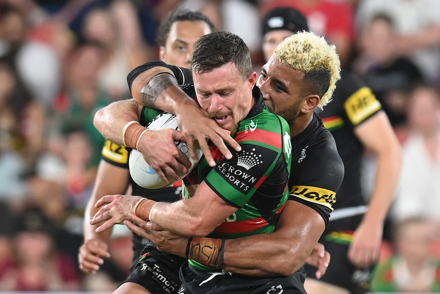 Rugby league player tackling another during a match