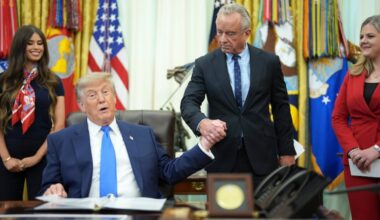 President Donald Trump and Health and Human Services Secretary Robert F. Kennedy Jr. at the signing of an executive order changing the guidelines for childhood vaccines on Aug. 10. The Trump administration has had a horrific impact on national health policy, write the authors.