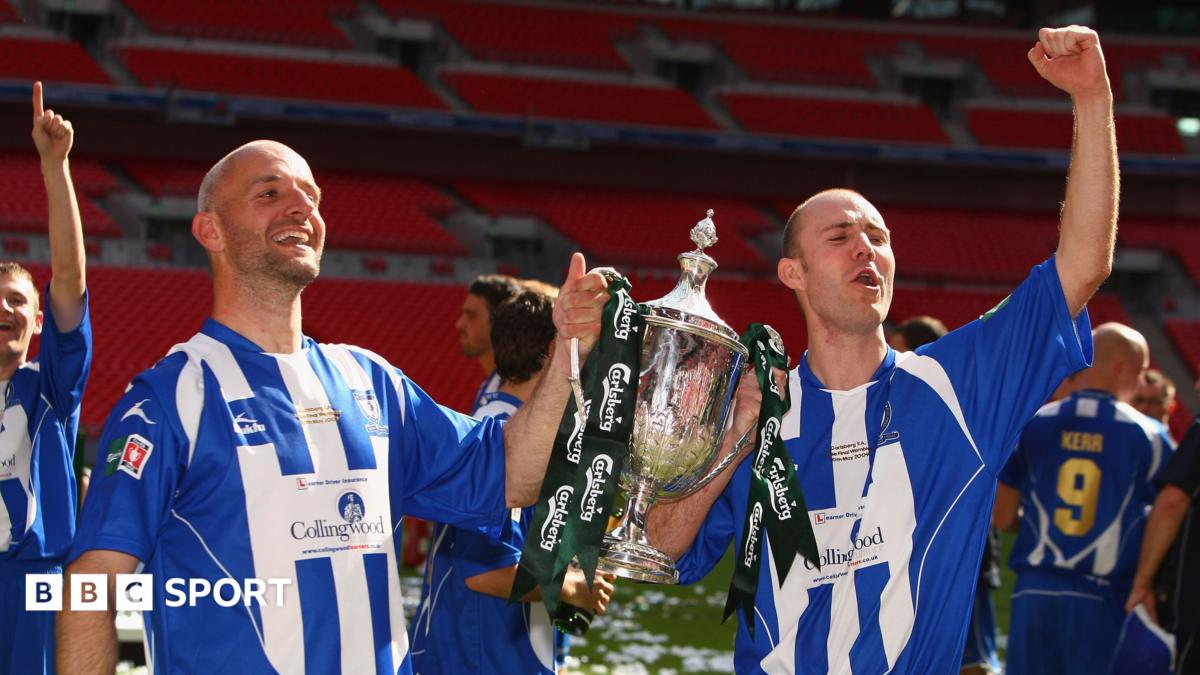 Whitley Bay strikers Paul Chow (left) and Lee Kerr celebrate with the FA Vase trophy