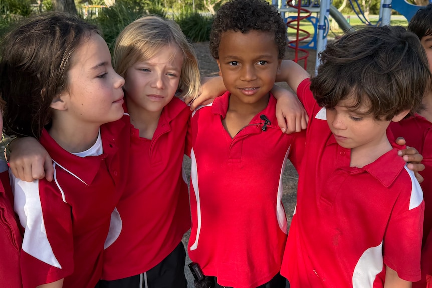group of young friends in red school shirts