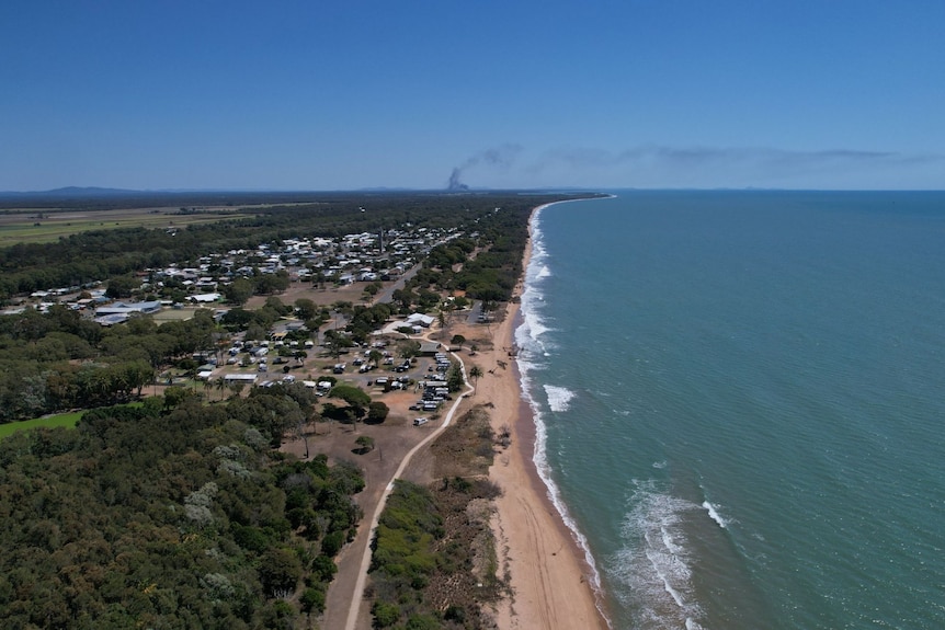 Aerial image of Moore Park beach and a township inland.