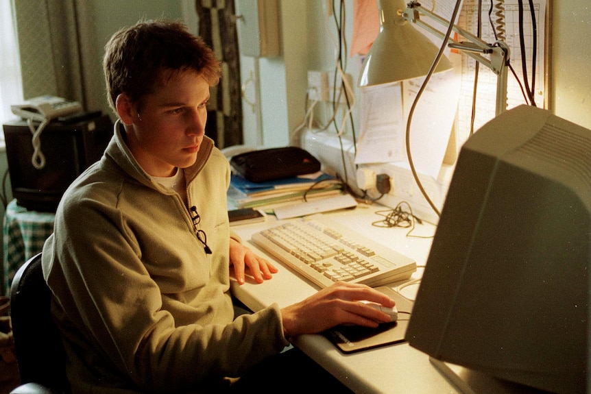 A young prince william uses a computer.
