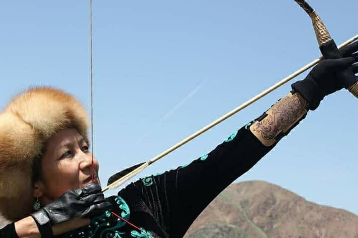 woman holds arrow.
