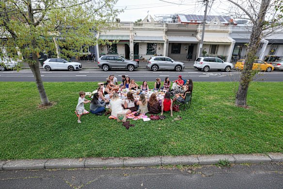 Melburnians enjoy a picnic on Drummond Street’s median strip on Friday. 