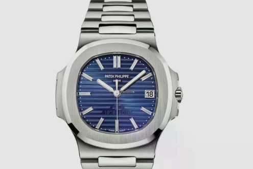 A silver watch with a dark blue face.