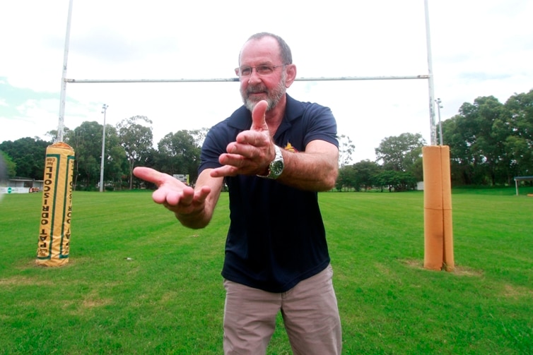 A man preparing to catch a football on a field