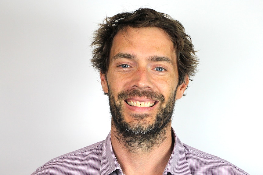 A man smiles at the camera.